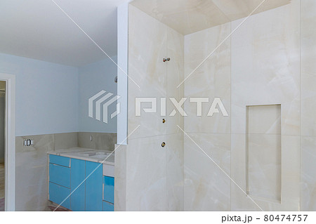 Home construction bathtub tiled walls after installing remodeling master bathroom patching drywall Home construction bathtub tiled walls after installing remodeling master bathroom patching drywall 80474757