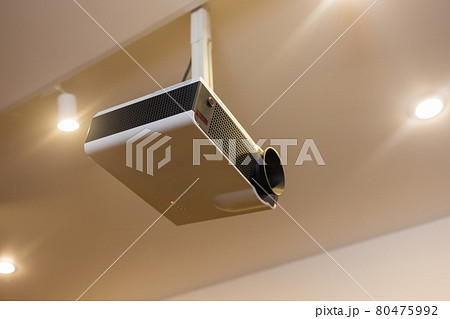 A white overhead projector on ceiling indoors. A white overhead projector on ceiling indoors. 80475992