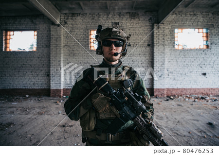 Close-up of a professional fully equipped soldier looking at camera. 80476253