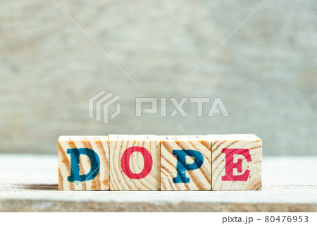 Alphabet letter block in word dope on wood background Alphabet letter block in word dope on wood background 80476953