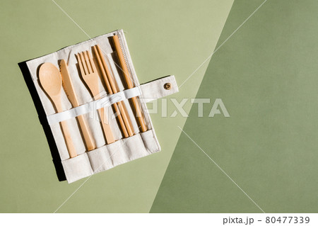 Set of Eco friendly bamboo cutlery on green background. Sustainable lifestyle. Plastic free concept. Zero waste concept. Place for text Set of Eco friendly bamboo cutlery on green background. Sustainable lifestyle. Plastic free concept. Zero waste concept. Place for text 80477339