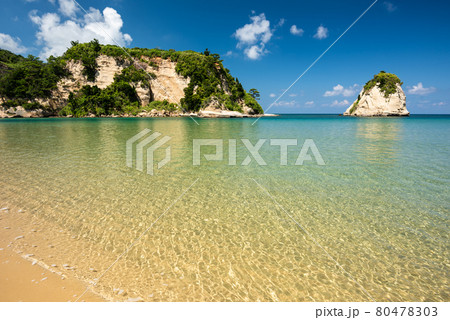 Breathtaking view of an emerald green sea beach, coastal rocks, blue sky. Iriomote Island. 80478303