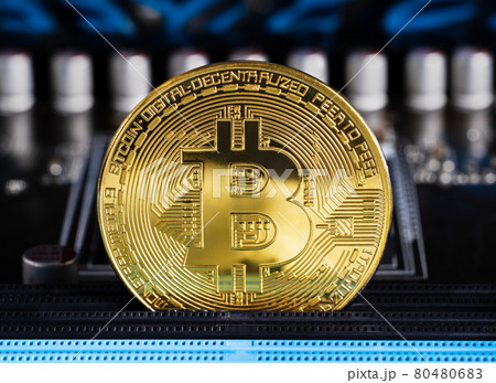 Cryptocurrency bitcoin coins on circuit board 80480683