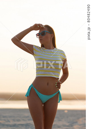 Sexy model in crop top and bikini panties on beach 80482490