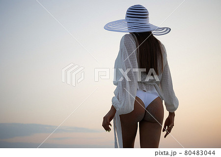 Stylish sensual woman in beachwear and hat 80483044