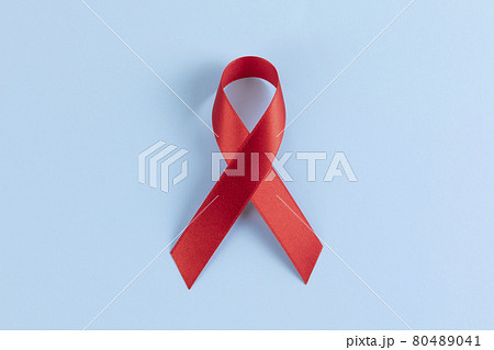 Red ribbon on sky blue background Red ribbon on sky blue background 80489041