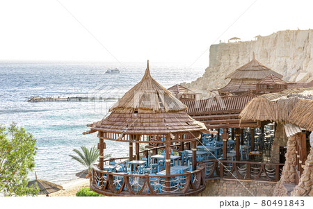 A restaurant complex on the seashore among the rocks. A restaurant complex on the seashore among the rocks. 80491843