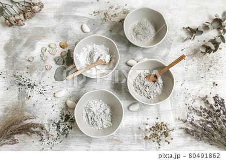 Spa composition with cosmetic clay powder on a textured background. 80491862