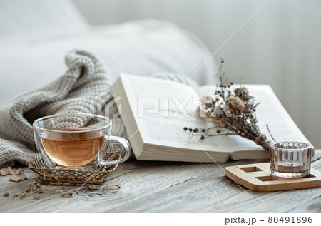 Home still life with a cup of tea and a book. 80491896