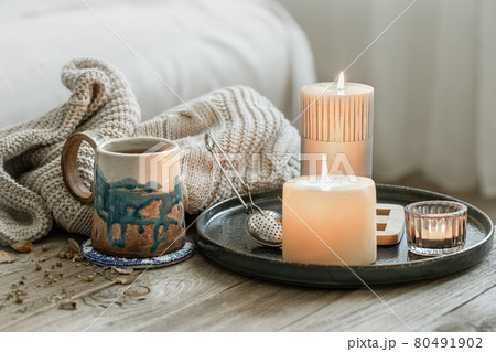 Home still life with a cup of tea and burning candles. 80491902