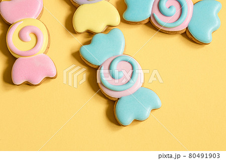 Bright cookies in glaze on a yellow background. 80491903