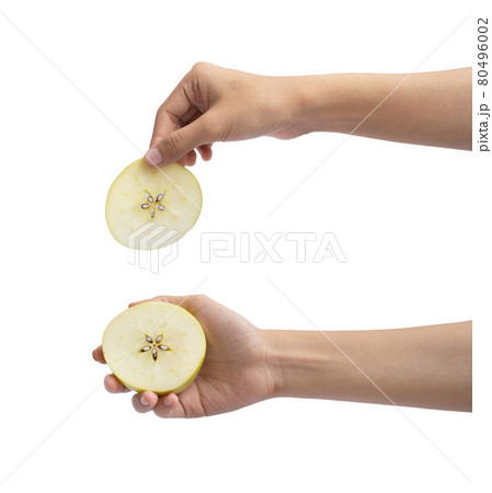Hand holding an apple. Fresh fruits. Raw organic healthy food. Grocery and supermarket cooking and eating isolated on white background. People Hand holding an apple. Fresh fruits. Raw organic healthy food. Grocery and supermarket cooking and eating isolated on white background. People 80496002