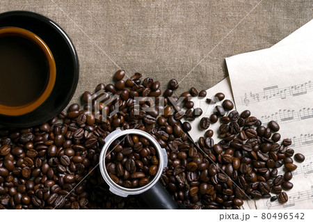 Coffee beans, sheet music and Coffee cup on a burlap background 80496542