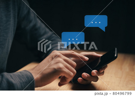 Young man using smartphone typing, chatting conversation with pop up chat box icons. Social Network, technology concept. 80496799