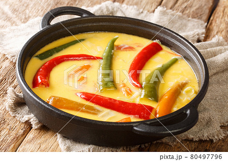 Green and red chillies abound in Ema datshi it is made from hot chili peppers and yak cheese closeup in the pan. horizontal 80497796