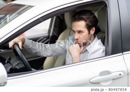 Annoyed tired young man riding driving car. Businessman late for meeting 80497859