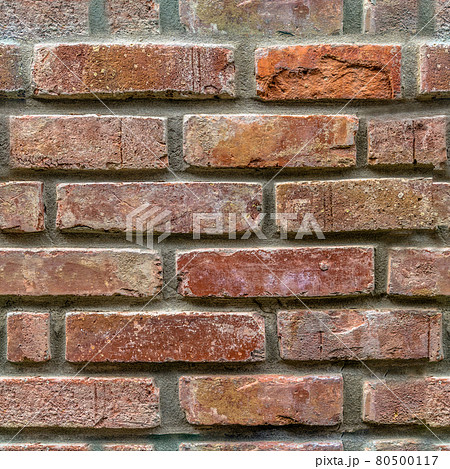 Endless seamless pattern of an old wall of restored bricks with a strongly faded red colour and uneven joints Endless seamless pattern of an old wall of restored bricks with a strongly faded red colour and uneven joints 80500117