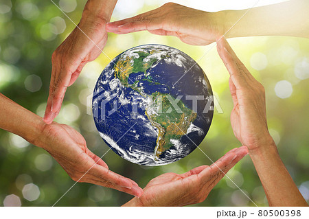 Hands holding planet earth on blurred green nature with sunlight background, elements of this image furnished by NASA, environmental concept Hands holding planet earth on blurred green nature with sunlight background, elements of this image furnished by NASA, environmental concept 80500398