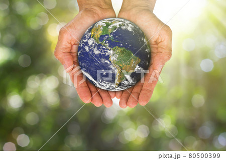 Hands holding planet earth on blurred green nature with sunlight background, elements of this image furnished by NASA, environmental concept Hands holding planet earth on blurred green nature with sunlight background, elements of this image furnished by NASA, environmental concept 80500399