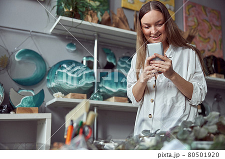 Young caucasian happy seller woman at botanic shop Young caucasian happy seller woman at botanic shop 80501920