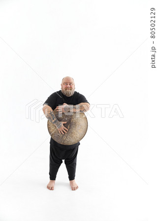 Funn caucasian bearded tattoed man is posing on white background 80502129