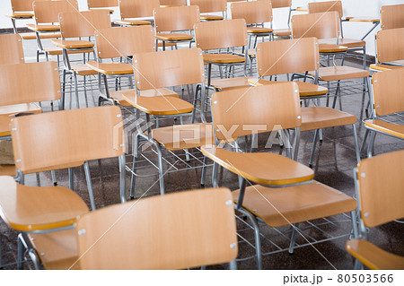 Wooden chairs in rows in classroom of school interior, no people 80503566