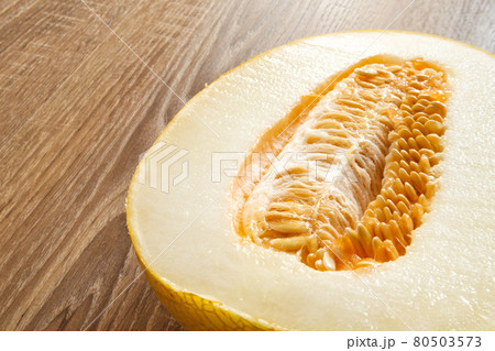 Melon cut in half with seeds close-up 80503573