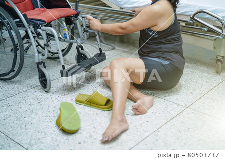 Asian middle-aged lady woman patient falling in living room because slippery surfaces Asian middle-aged lady woman patient falling in living room because slippery surfaces 80503737