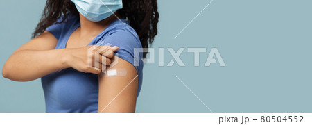 Antiviral vaccination. African american woman showing plaster on shoulder after covid-19 vaccine injection, panorama Antiviral vaccination. African american woman showing plaster on shoulder after covid-19 vaccine injection, panorama 80504552