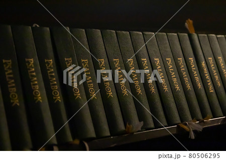 Porvoo, Finland - 2 October 2019: Closeup of a row of green hymn books on swedish language in Porvoo Cathedral. 80506295