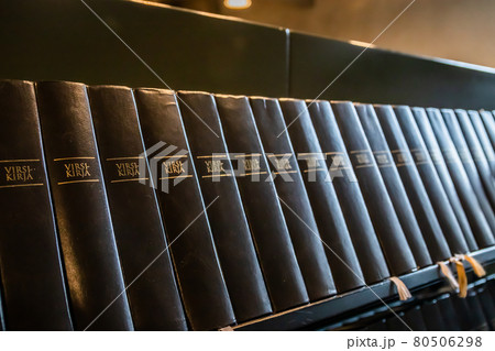 Porvoo, Finland - 2 October 2019: Closeup of a row of green hymn books on finnish language in Porvoo Cathedral. Porvoo, Finland - 2 October 2019: Closeup of a row of green hymn books on finnish language in Porvoo Cathedral. 80506298