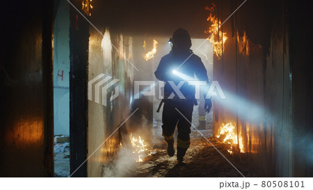 Firemen examining burning corridor during rescue operation Firemen examining burning corridor during rescue operation 80508101