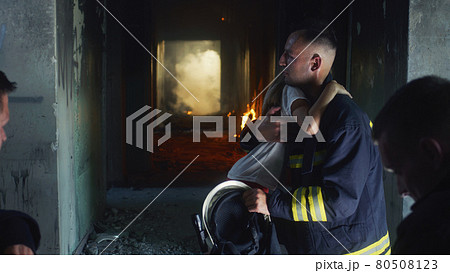 Firemen interrogating saved girl in burning building Firemen interrogating saved girl in burning building 80508123