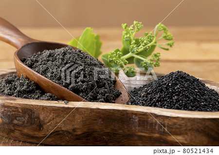 Black sesame seeds filled with wooden bowl and spoon 80521434