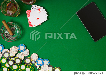 Set to playing poker with cards and chips on green table, top view 80522671