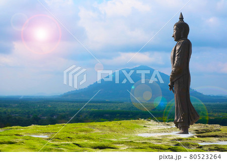 Buddha looking seven day style and sun back cloud over mountain background 80523264