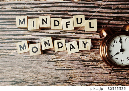 Mindful Monday letters and alarm clock on wooden background 80525526
