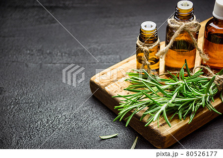 Rosemary essential oil on black background Rosemary essential oil on black background 80526177