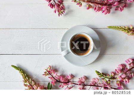 coffee cup with saucer and pink lupine flowers on board white wooden background. Place for your text and product, copy space, top view, flatlay. coffee cup with saucer and pink lupine flowers on board white wooden background. Place for your text and product, copy space, top view, flatlay. 80528516