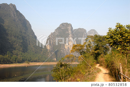 A path alongside the Li River between Guilin and Yangshuo in Guangxi Province, China. The karst hills and river scenery have provided inspiration for artists and poets. Li River scenery, Guilin. A path alongside the Li River between Guilin and Yangshuo in Guangxi Province, China. The karst hills and river scenery have provided inspiration for artists and poets. Li River scenery, Guilin. 80532858