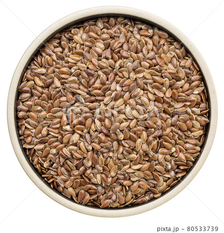 brown flax seeds in a round bowl 80533739
