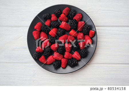 Fresh organic summer berries mix in round black table Fresh organic summer berries mix in round black table 80534158