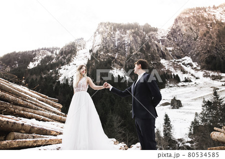 Wedding couple holding hands, groom and bride together on wedding day 80534585