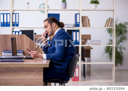 Young male employee working in the office Young male employee working in the office 80535094