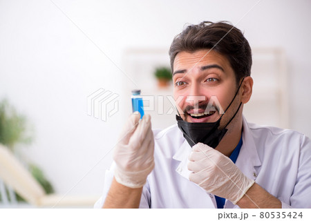 Young male chemist in pandemic concept Young male chemist in pandemic concept 80535424