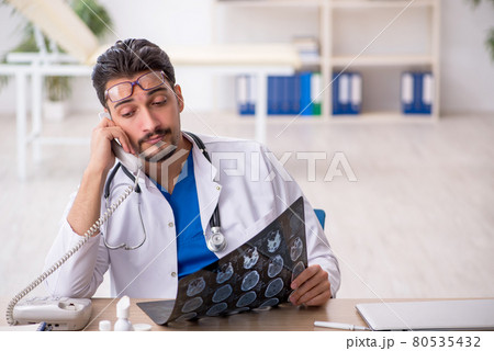Young male doctor radiologist working in the clinic Young male doctor radiologist working in the clinic 80535432