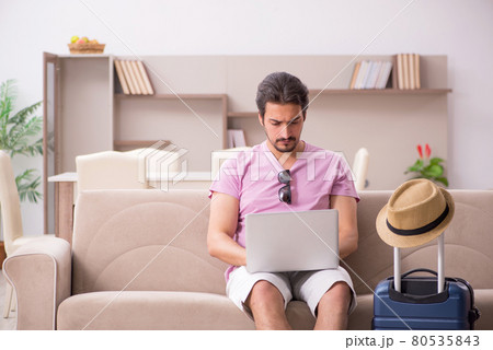 Young man preparing for trip at home Young man preparing for trip at home 80535843