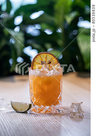 lemonade in glass or refreshing drink with orange juice, lime and ice on table 80536839