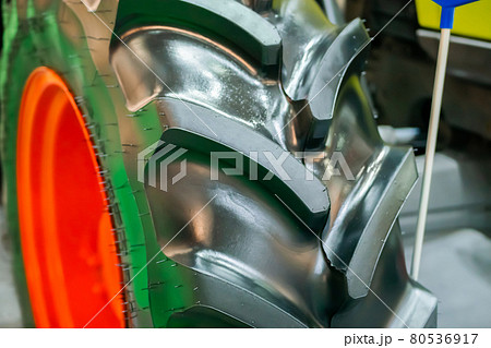 Close up view of heavy tractor tire and wheel at farming exhibition Close up view of heavy tractor tire and wheel at farming exhibition 80536917