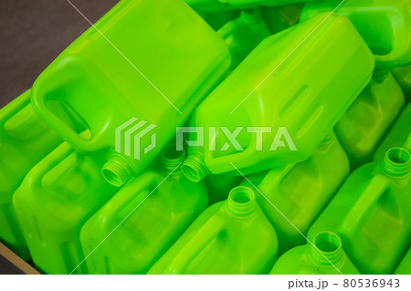 Many empty green plastic jerrycans 80536943